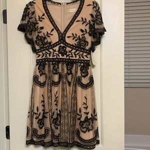 Beautiful, NEW dress with black trim over lined skirting. Beige and black.